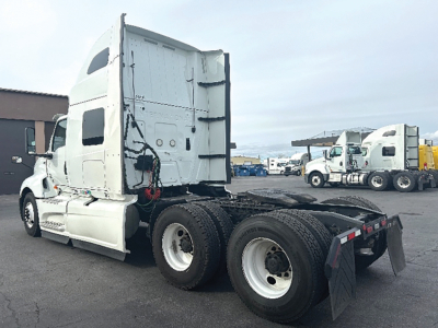 Truck tractor cab and chassis in view showing rear dual axle and fifth-wheel area