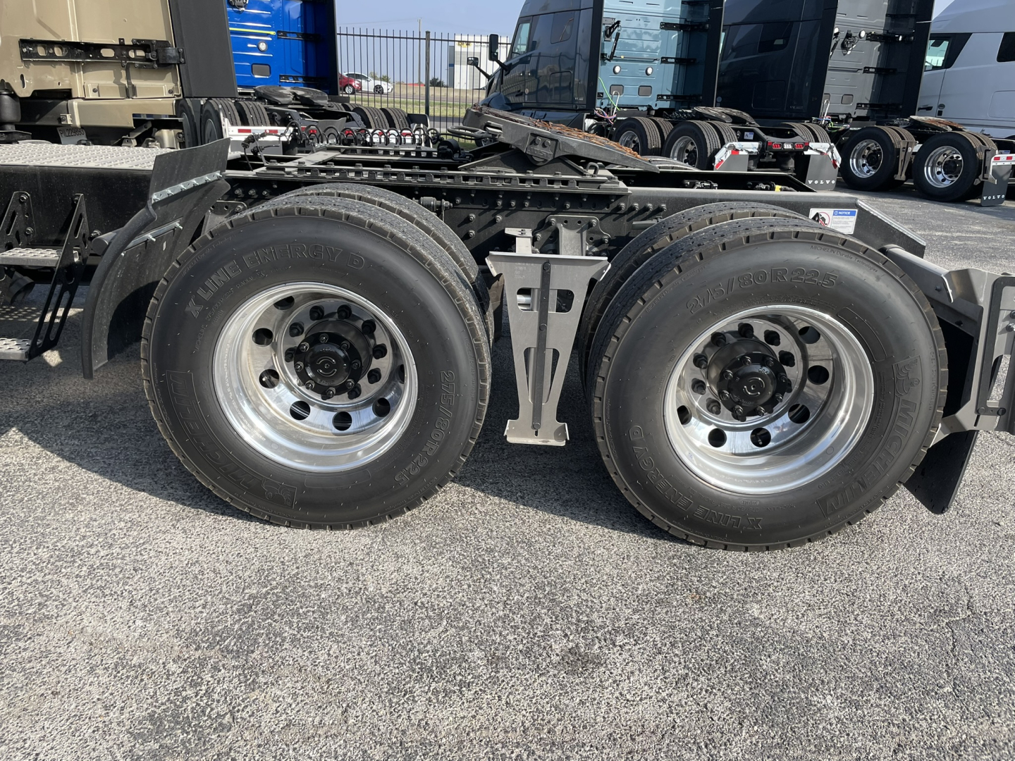 Dual rear tractor axles and tires of a Volvo VNL64T860 truck chassis showing dual wheels and suspension components.