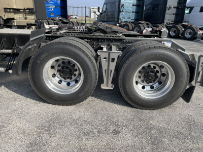 Dual rear tractor axles and tires of a Volvo VNL64T860 truck chassis showing dual wheels and suspension components.