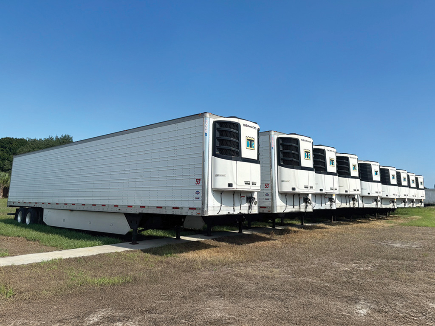 2019 Utility 3000R trailer side view with multiple refrigerated units and raised landing gear.