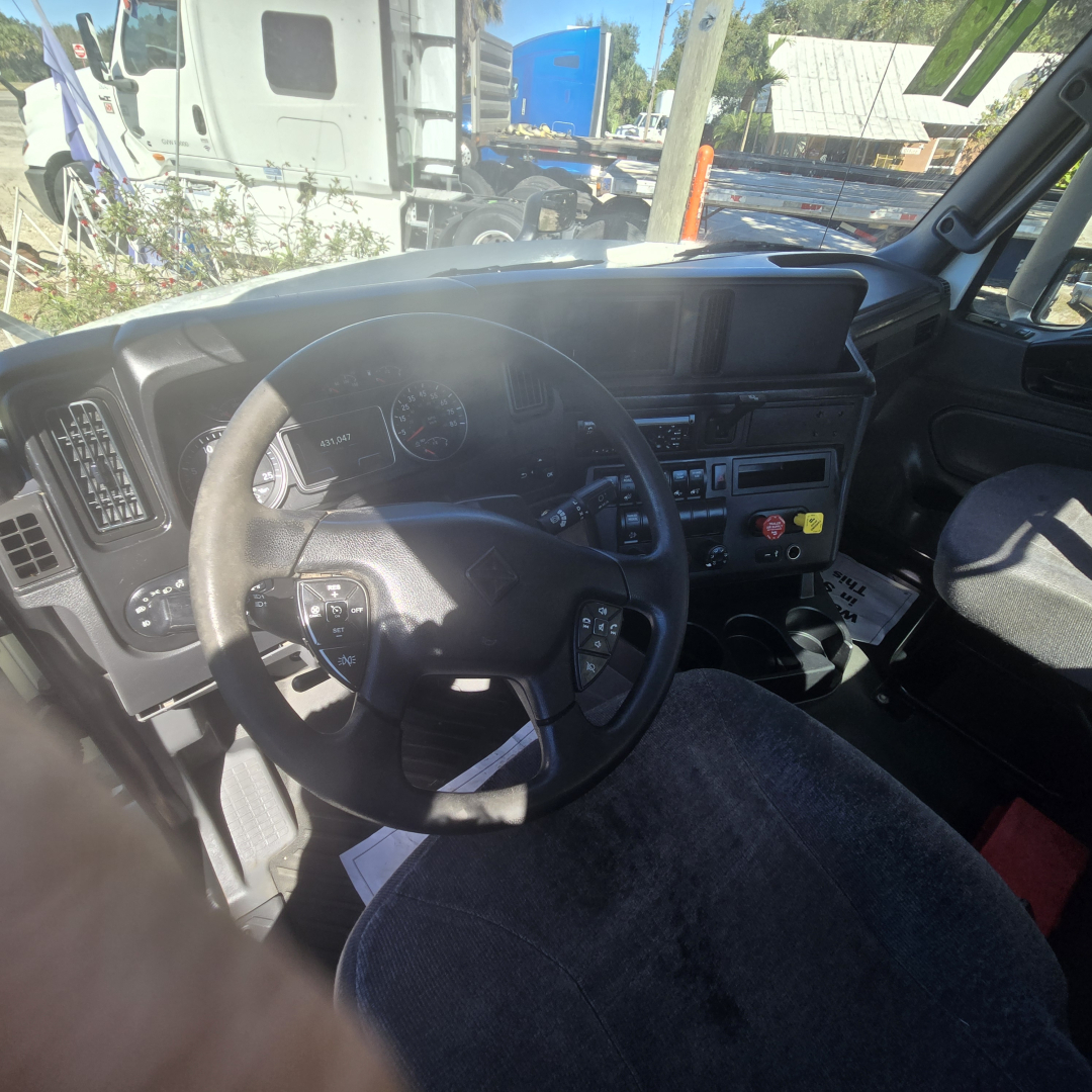 Truck cab interior showing steering wheel and dashboard of 2018 International LT625 conventional daycab.