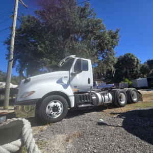 2018 International LT625 conventional daycab tractor side view showing cab, fuel tanks, and rear axles.