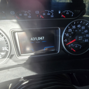 Dashboard view of a 2018 International LT625 conventional truck showing a 431,047 miles odometer on the digital display and speedometer gauges.