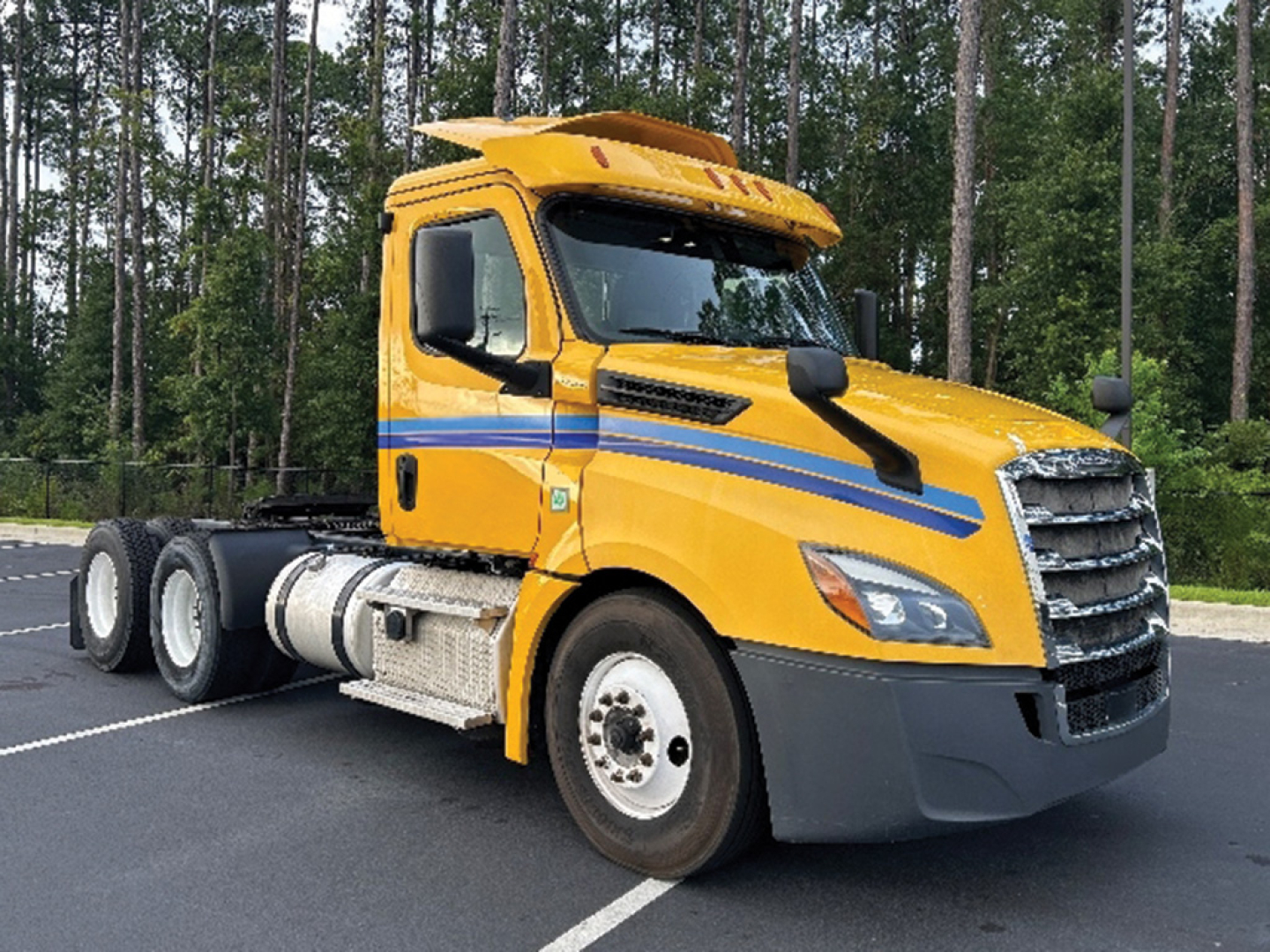 2019 Freightliner Cascadia126 truck in yellow with blue accent lines, side view showing cab and front grille.