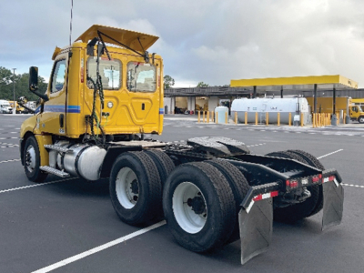 Freightliner Cascadia 126 tractor rear view with yellow cab and black chassis; dual rear axles; fuel tanks and exhaust visible.