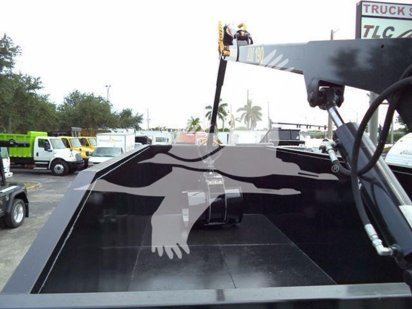 2020 Peterbilt 337 grapple truck bed with hydraulic lifting arm and control hoses visible