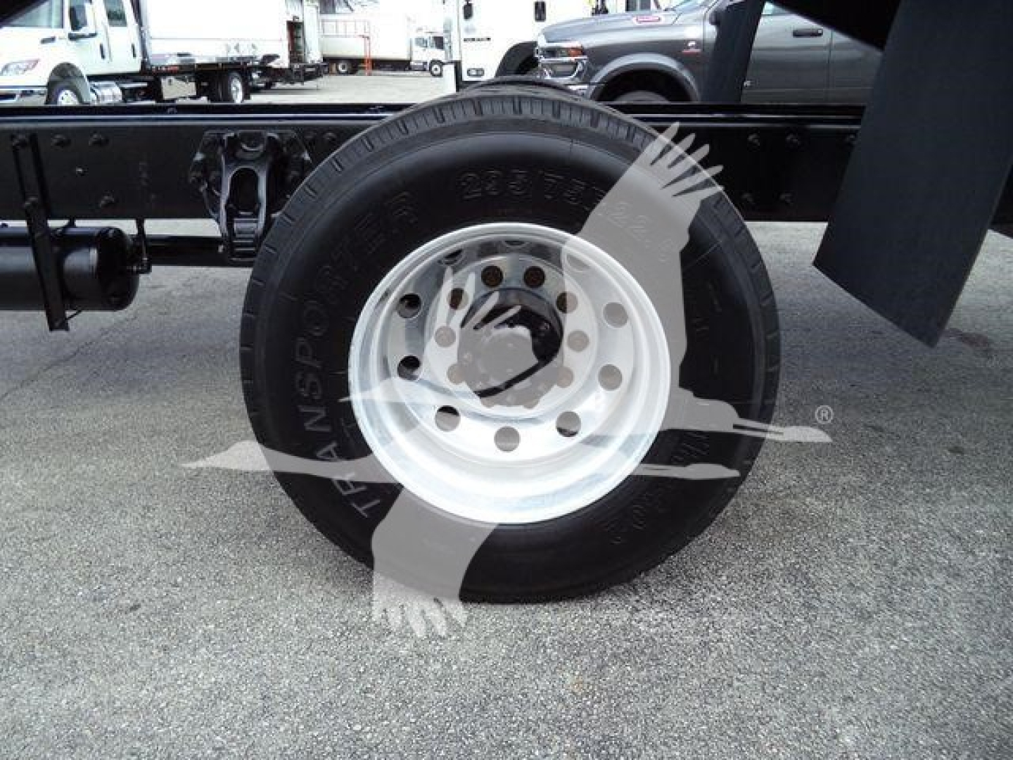 Wheel and tire on a Peterbilt three-seven chassis showing steel rim, hubcap area, and surrounding frame.