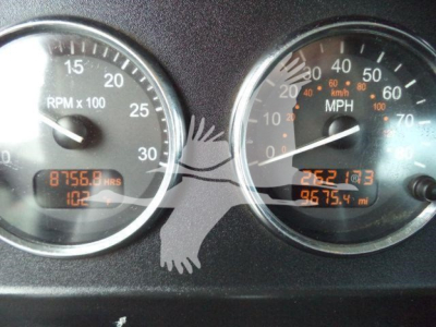 Gauges in Peterbilt 337 dashboard showing tachometer and speedometer with hours and miles readouts.