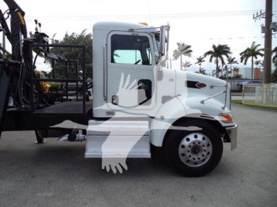 Peterbilt 337 grapple truck in-cab and chassis side view, white with logo graphics, front wheel and step visible.