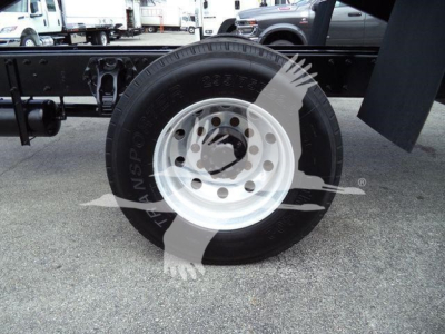 Wheel and tire on a Peterbilt three-seven chassis showing steel rim, hubcap area, and surrounding frame.