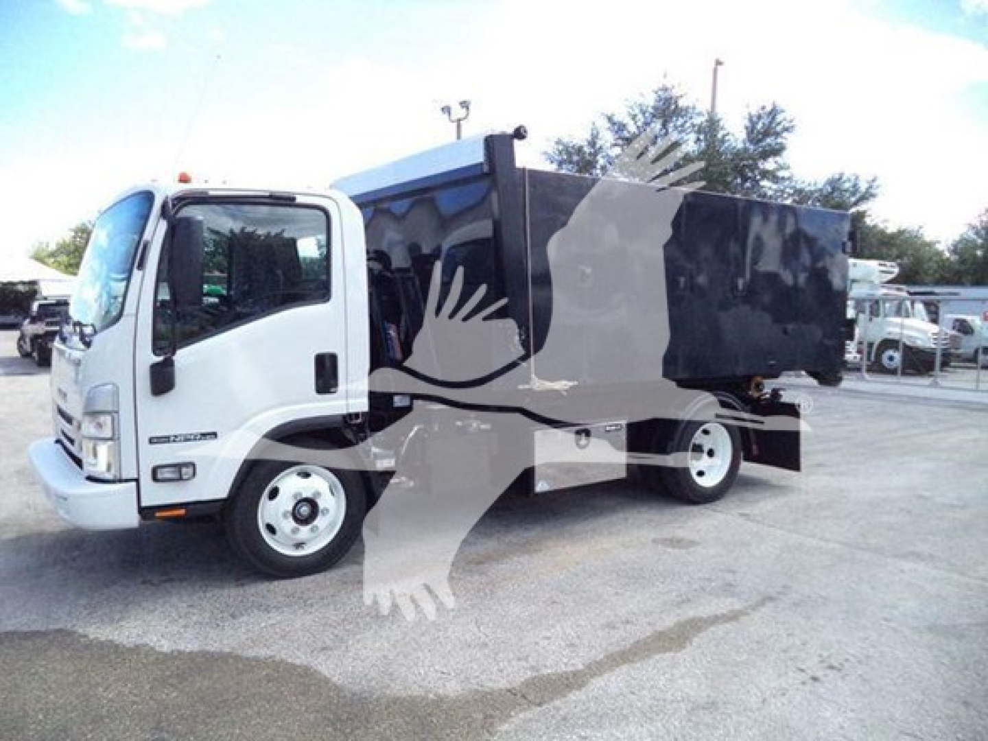 Isuzu NPR HD hooklift truck in side view with black dump body, white cab, and overlay watermark. Visible text includes 2024 Isuzu NPR HD listing and truck graphics.