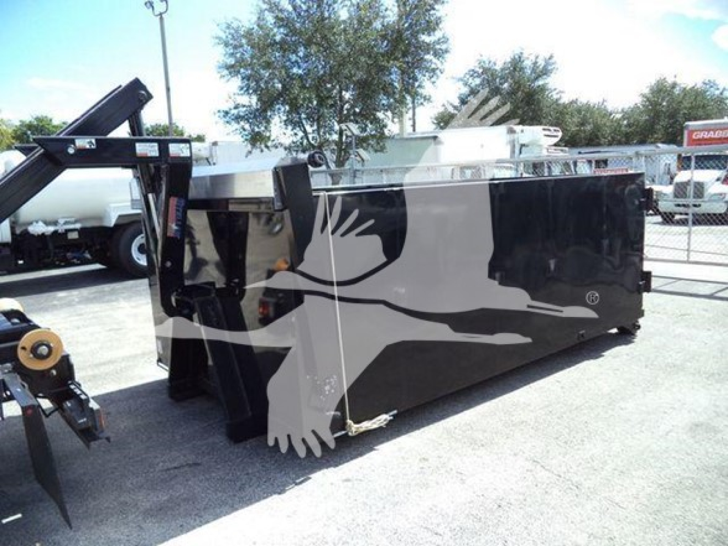 Isuzu NPR HD hooklift truck body showing side panel with silhouette eagle graphic and hydraulic components at front.