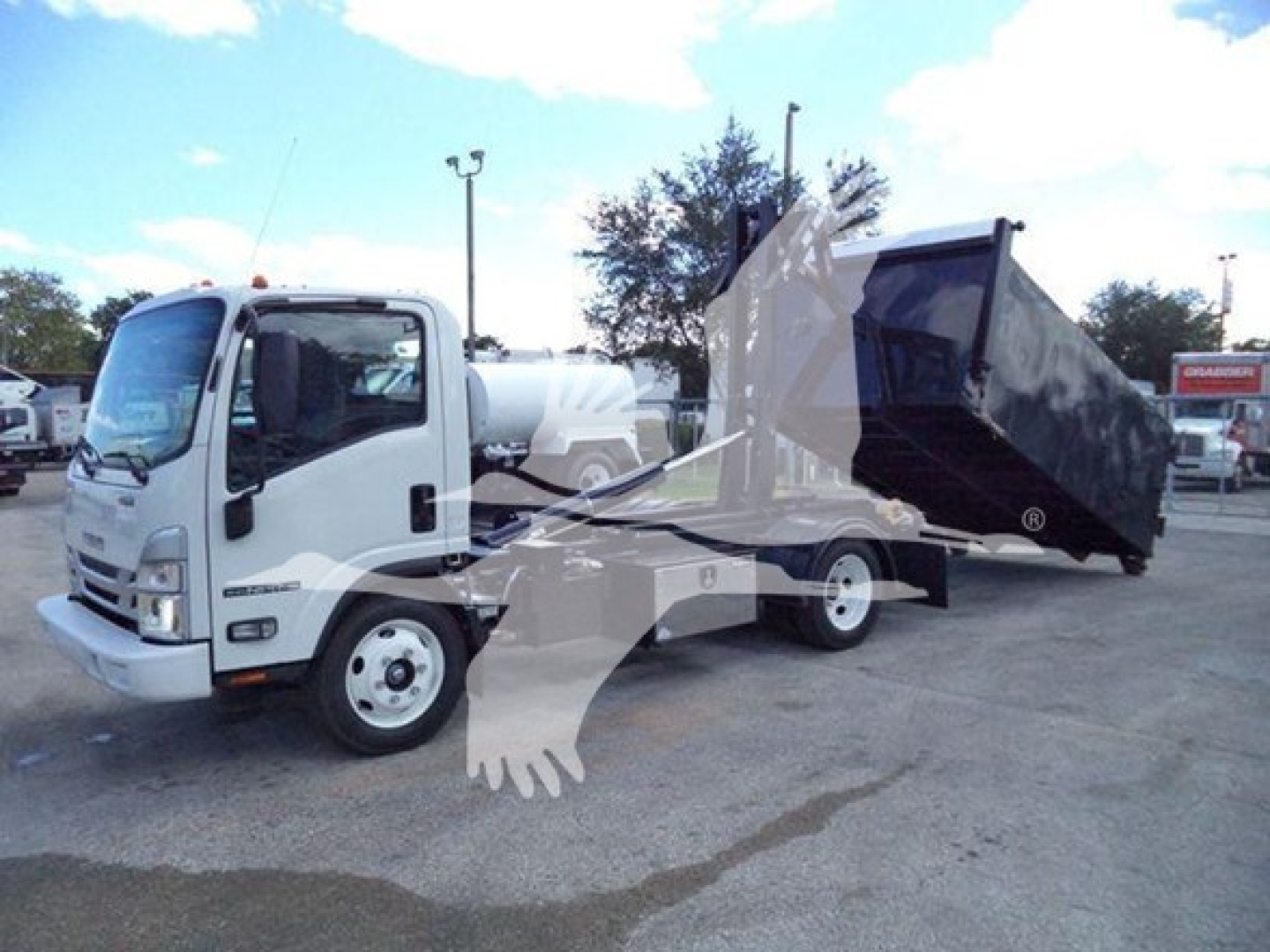 Isuzu NPR-HD truck with a large dump bed raised. Side view shows cab and dump body with hydraulic mechanism. No legible labels visible.