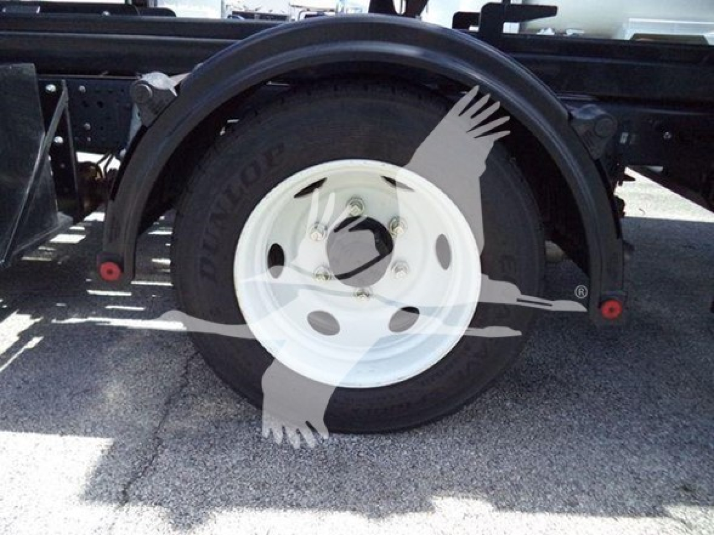 Isuzu NPR HD wheel and tire assembly showing white rim and black tire.