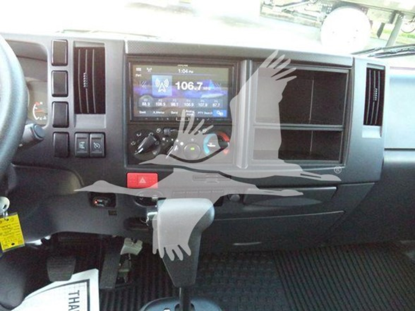 Isuzu NPRHD truck dashboard/center console showing radio display and HVAC controls.