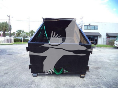 Rear view of Isuzu NPR-HD truck with a black hydraulic hooklift body, green straps, and a compact chassis visible; no plates legible.