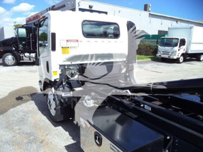 Isuzu NPR-HD truck cab viewed from rear-right with hooklift chassis and auxiliary equipment mounted on frame.