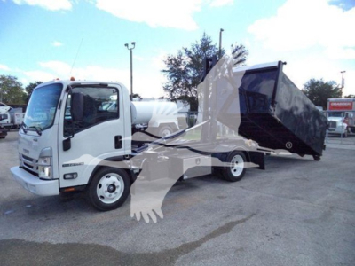 Isuzu NPR-HD truck with a large dump bed raised. Side view shows cab and dump body with hydraulic mechanism. No legible labels visible.