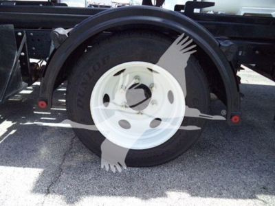 Isuzu NPR HD wheel and tire assembly showing white rim and black tire.