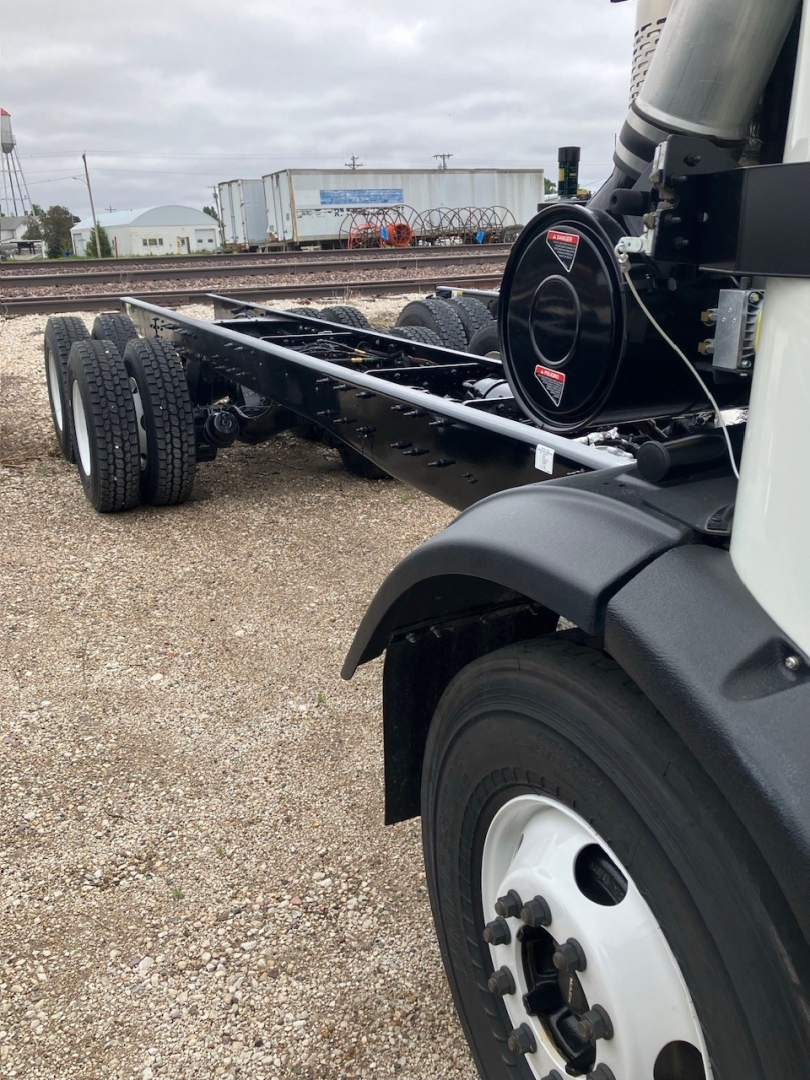 Mack LR64 cab and chassis front wheel and frame showing structural chassis rails and fuel or air tanks.