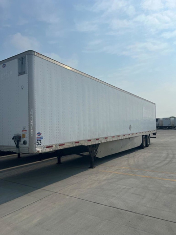 A white utility trailer with a long rectangular cargo area, showing a front left corner, hitch and landing gear; some small text and numbers along the side and rear edge.