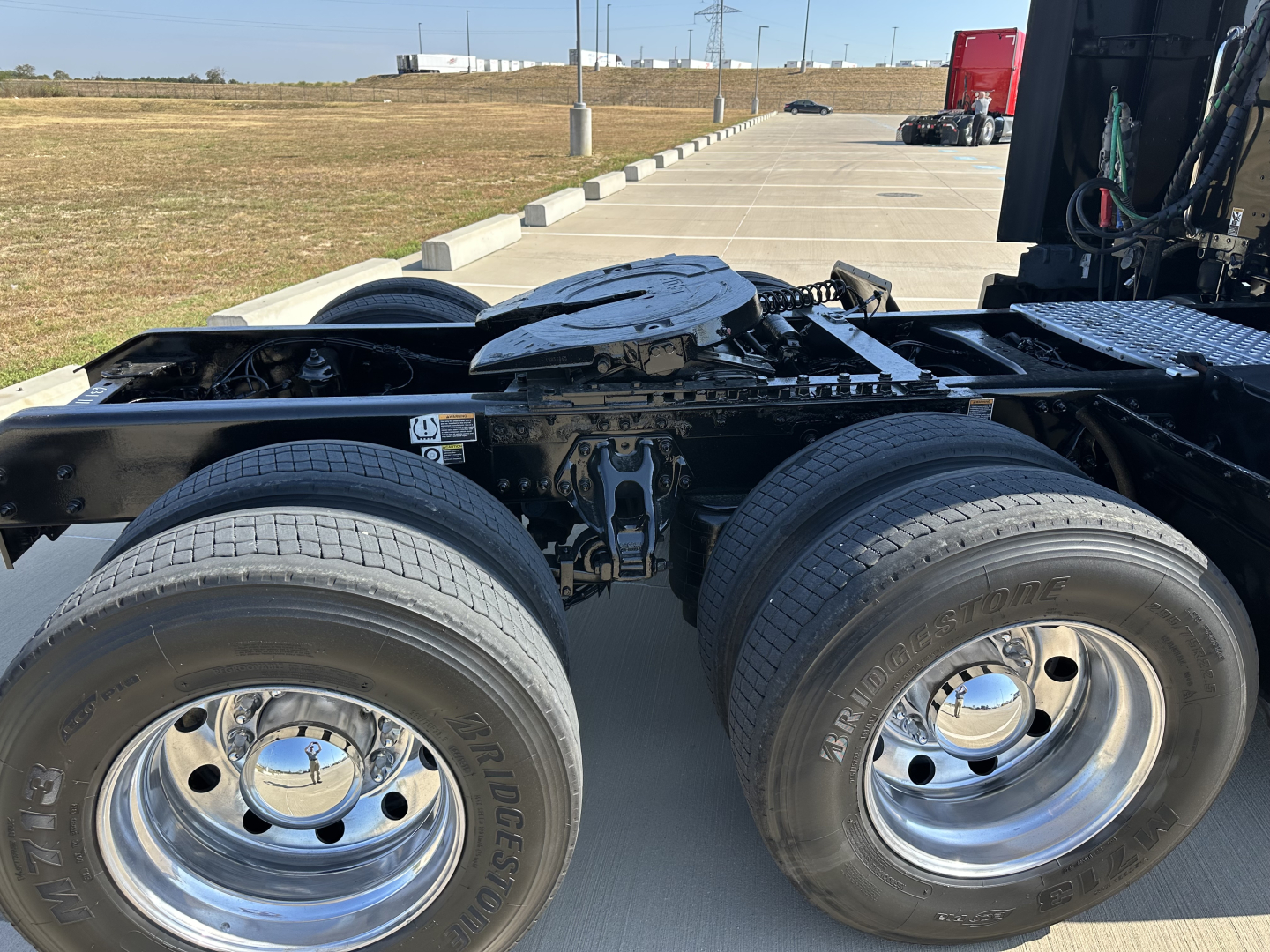 Kenworth T680 chassis showing dual rear axle wheels and fuel tanks with visible wheels and undercarriage.