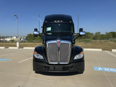 Kenworth T680 front view showing large chrome grille, headlights, and black hood.