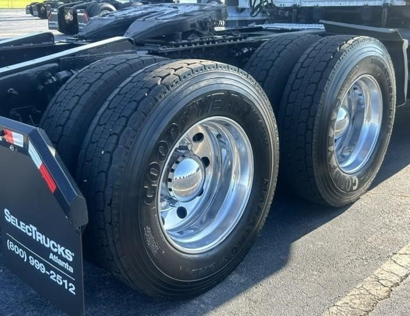 Rear dual-wheel Freightliner Cascadia 126 truck chassis with Goodyear tires and polished aluminum rims.
