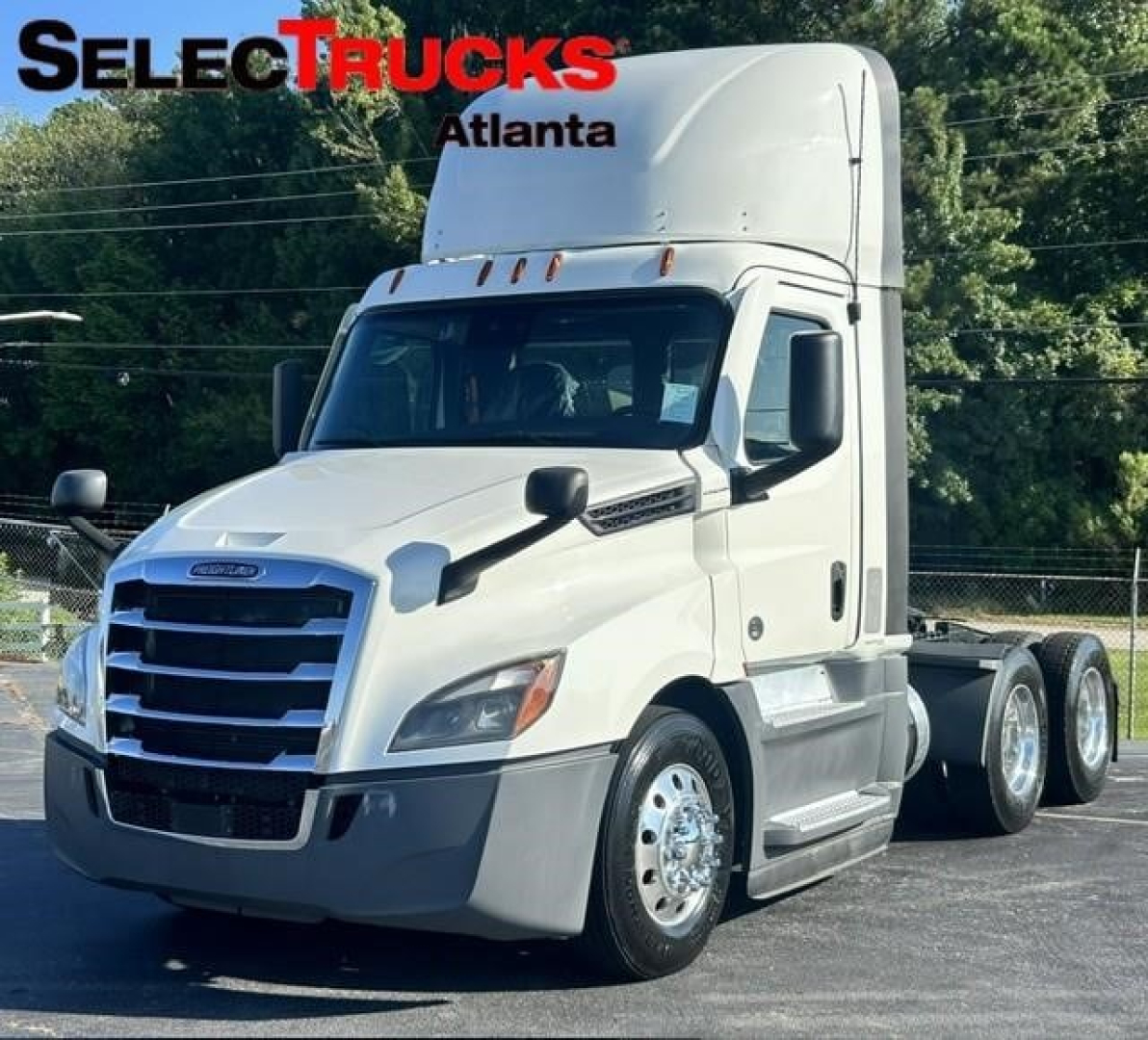 Truck cab and chassis showing 2021 Freightliner Cascadia 126 with sleeper, white exterior, front grille, and dual rear axles.