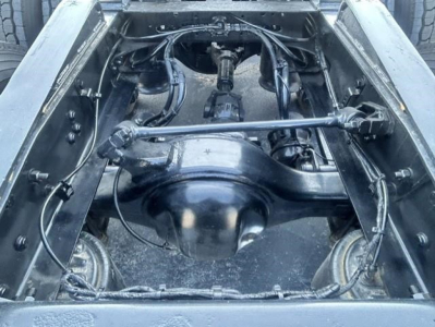 Freightliner Cascadia 126 chassis view showing rear axle differential and drive shaft in a truck bed, with suspension and wiring visible.