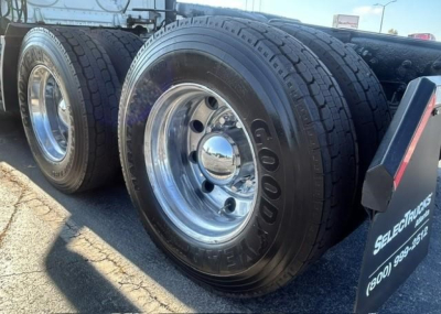 Truck rear dual tires on a Freightliner Cascadia 126 trailer with Goodyear tires and chrome rims.
