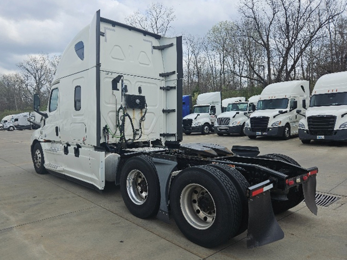 Freightliner Cascadia126 tractor rear view showing cab and dual rear axles with fifth wheel and air lines