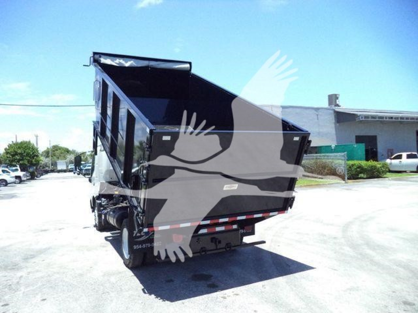 Dump truck bed raised on a 2020 Hino 195 dump truck with rear view showing hydraulic mechanism and bed, no legible model text visible on image.