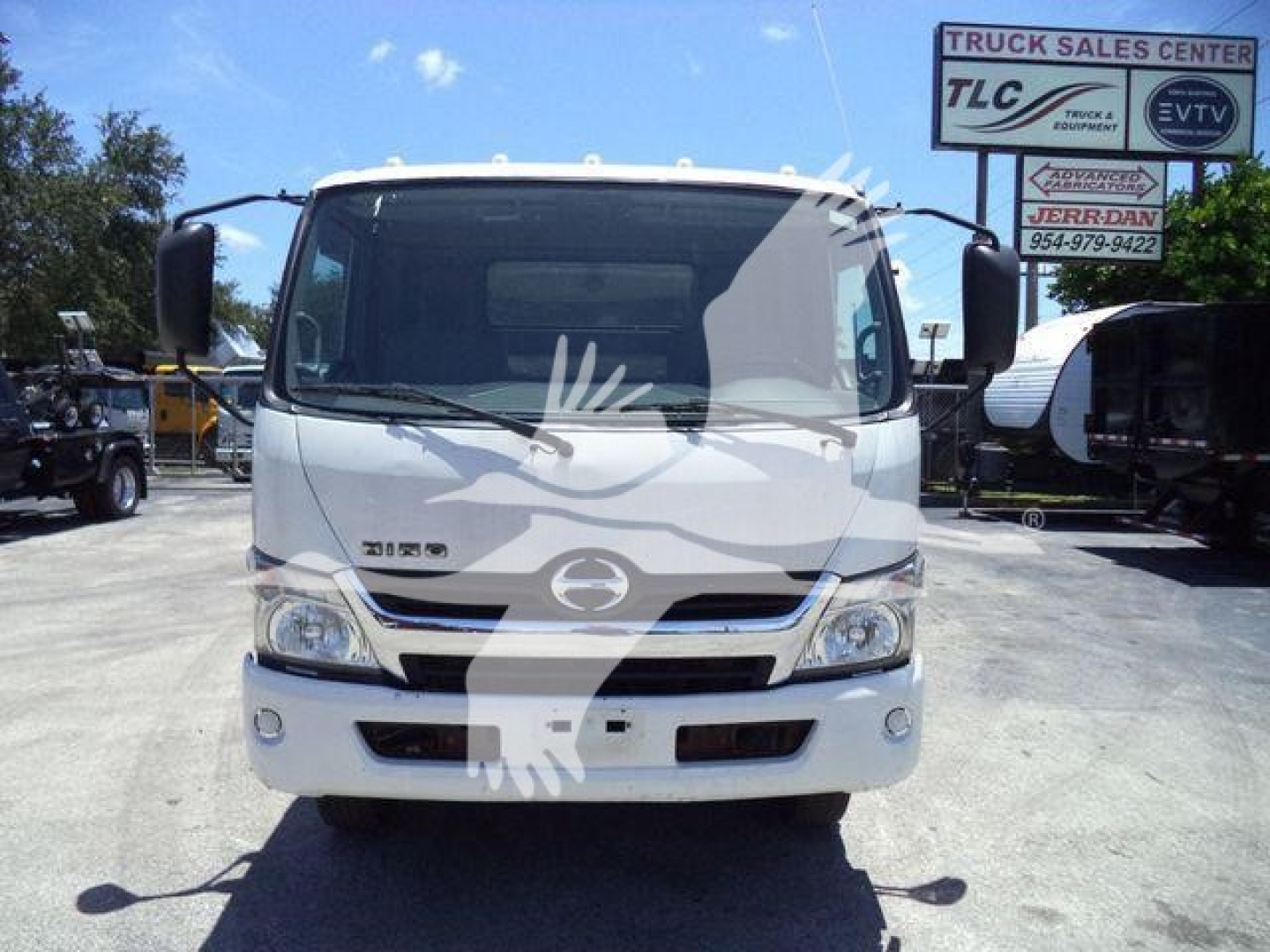 Front view of a white 2020 Hino 195 dump truck showing grille, headlights, and Hino emblem.