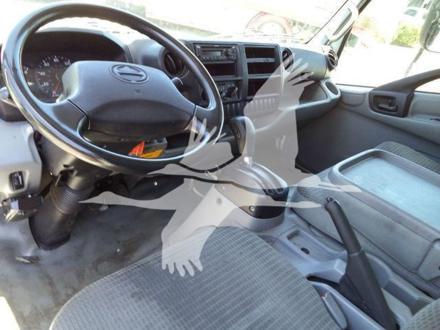 Interior of a 2020 Hino 195 cab showing steering wheel, dashboard, and driver's seat; no legible labels or model text visible on components.