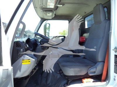 Truck cab interior of a 2020 Hino 195 with grey seats and steering wheel visible