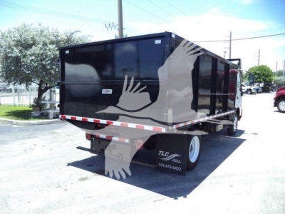 Back view of a black 2020 Hino 195 dump truck with dove-themed graphics on the side and dual rear wheels.