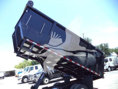Dump truck in dump position showing raised cargo bed with hydraulic lift in a used Hino 195 listing; visible text not legible.