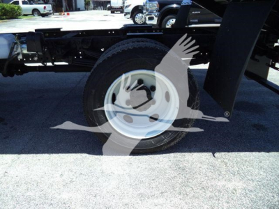 Truck wheel and undercarriage of a 2020 Hino 195 dump truck showing a white steel wheel with tire and chassis components.