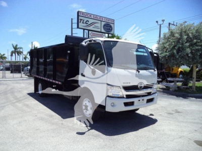 Hino 195 dump truck front and side view showing cab with large windshield, dual headlights, and black dump bed.