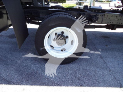 65-degree side view of a wheel on a 2020 Hino 195 dump truck chassis showing single white steel wheel and tire, undercarriage and frame.