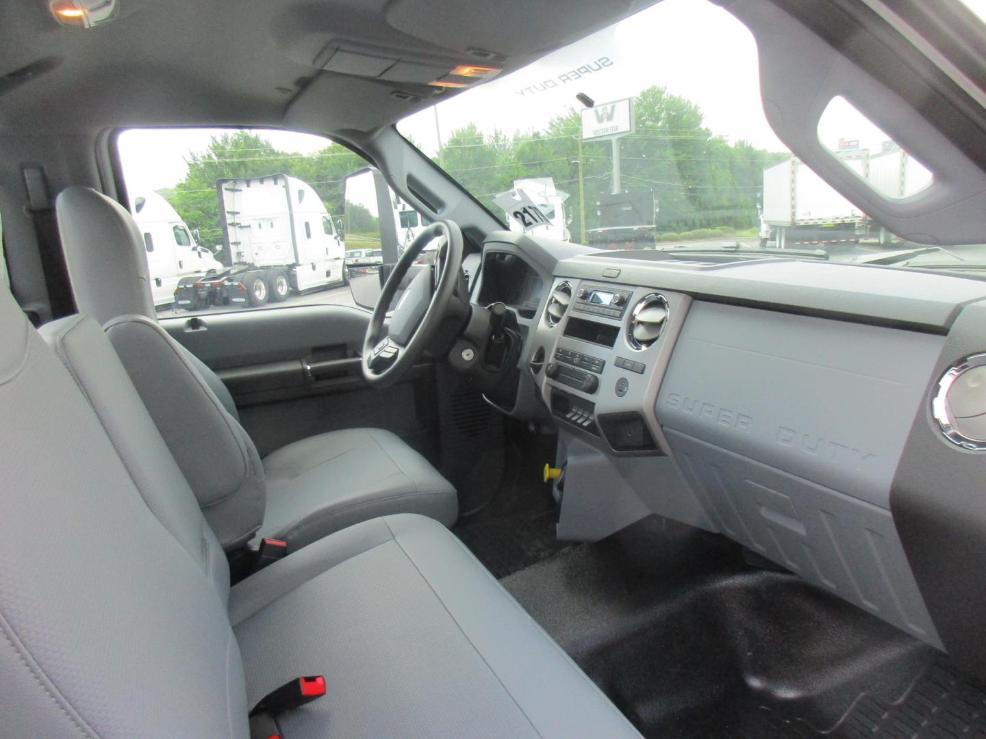 Ford F-750 Cab and Chassis interior view showing steering wheel, dashboard, and front seats.