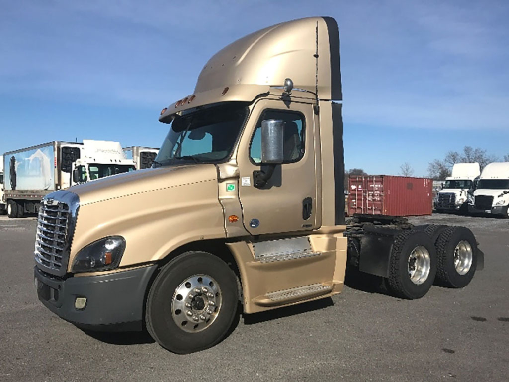 Freightliner Cascadia Evolution 125 truck cab in tan color with sleeper, side view showing front wheel and dual rear axles.