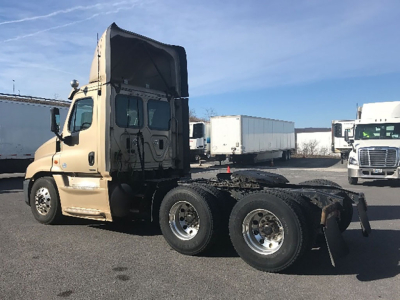Freightliner Cascadia125 Evolution tractor cab side profile showing dual rear axles and sleeper area in beige color
