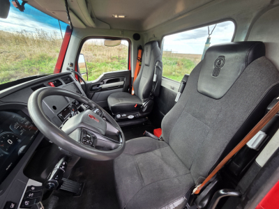Kenworth T680 truck cab interior showing driver's seat and passenger seat with steering wheel and dashboard visible.