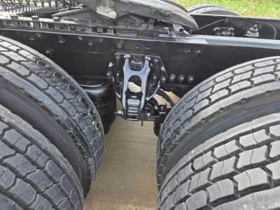 Kenworth T680 chassis center view showing rear axle suspension and fifth wheel mount with dual rear tires.