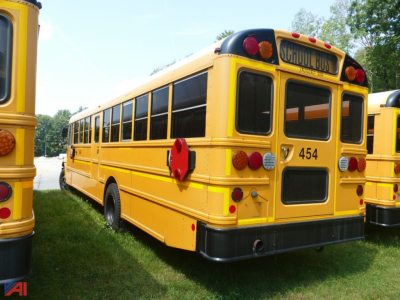 School bus rear and side view showing yellow 2019 International CE 3000 school bus with #454, black bumper, rear lights, and SCHOOL BUS sign.