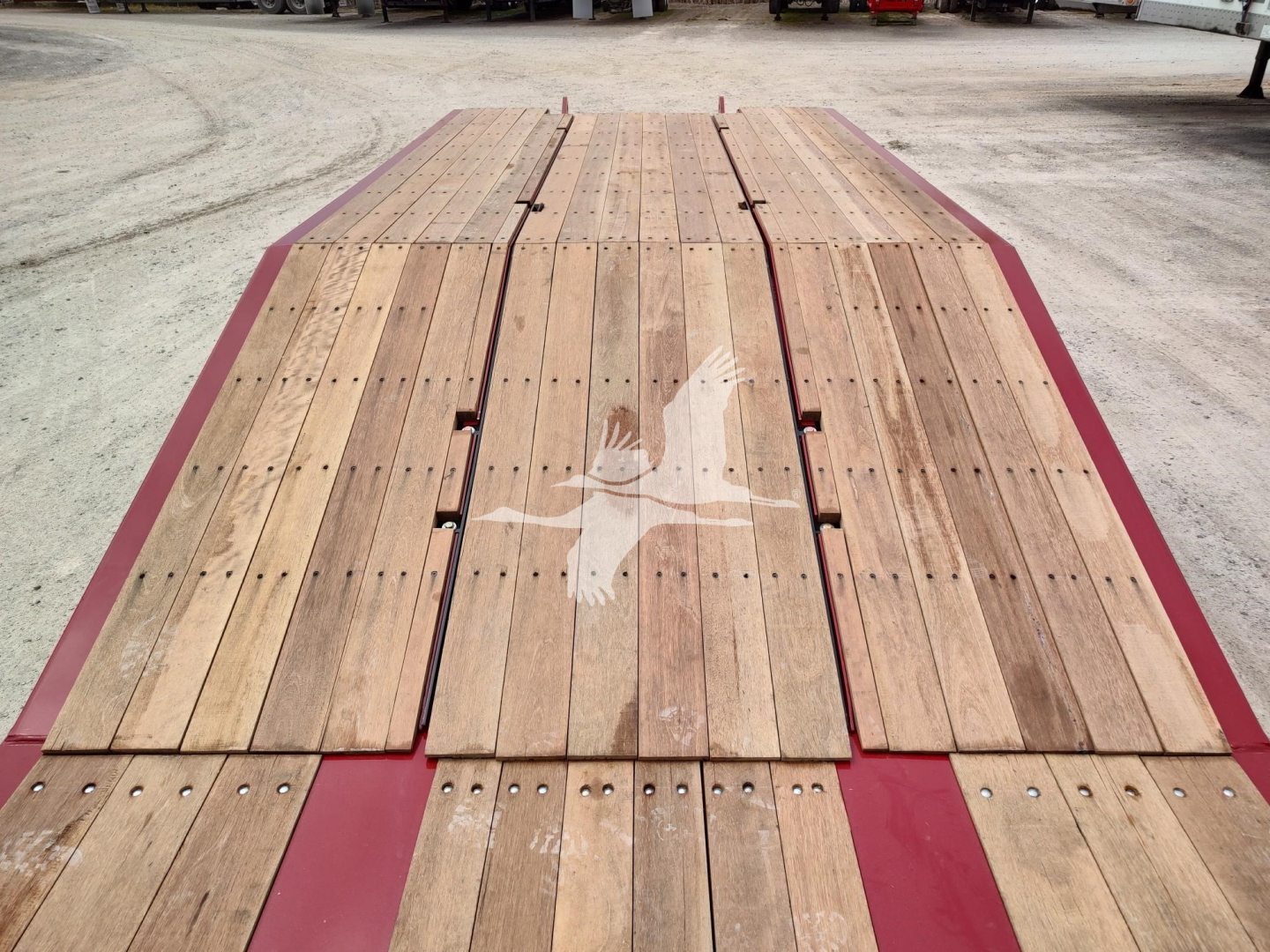 Lowboy trailer deck with wooden planks and red painted frame showing Fontaine branding.
