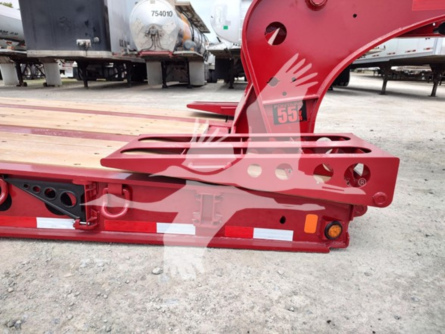 Red Fontaine lowboy trailer component with cutouts and reflective tape showing structural rail and mounting holes.