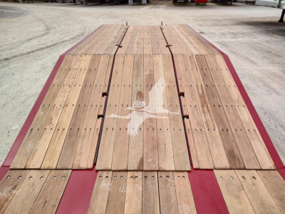 Lowboy trailer deck with wooden planks and red painted frame showing Fontaine branding.